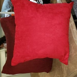 2 Pillows one red, and purple.